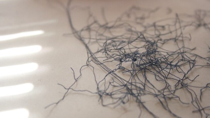 Tangled dark threads on light surface
